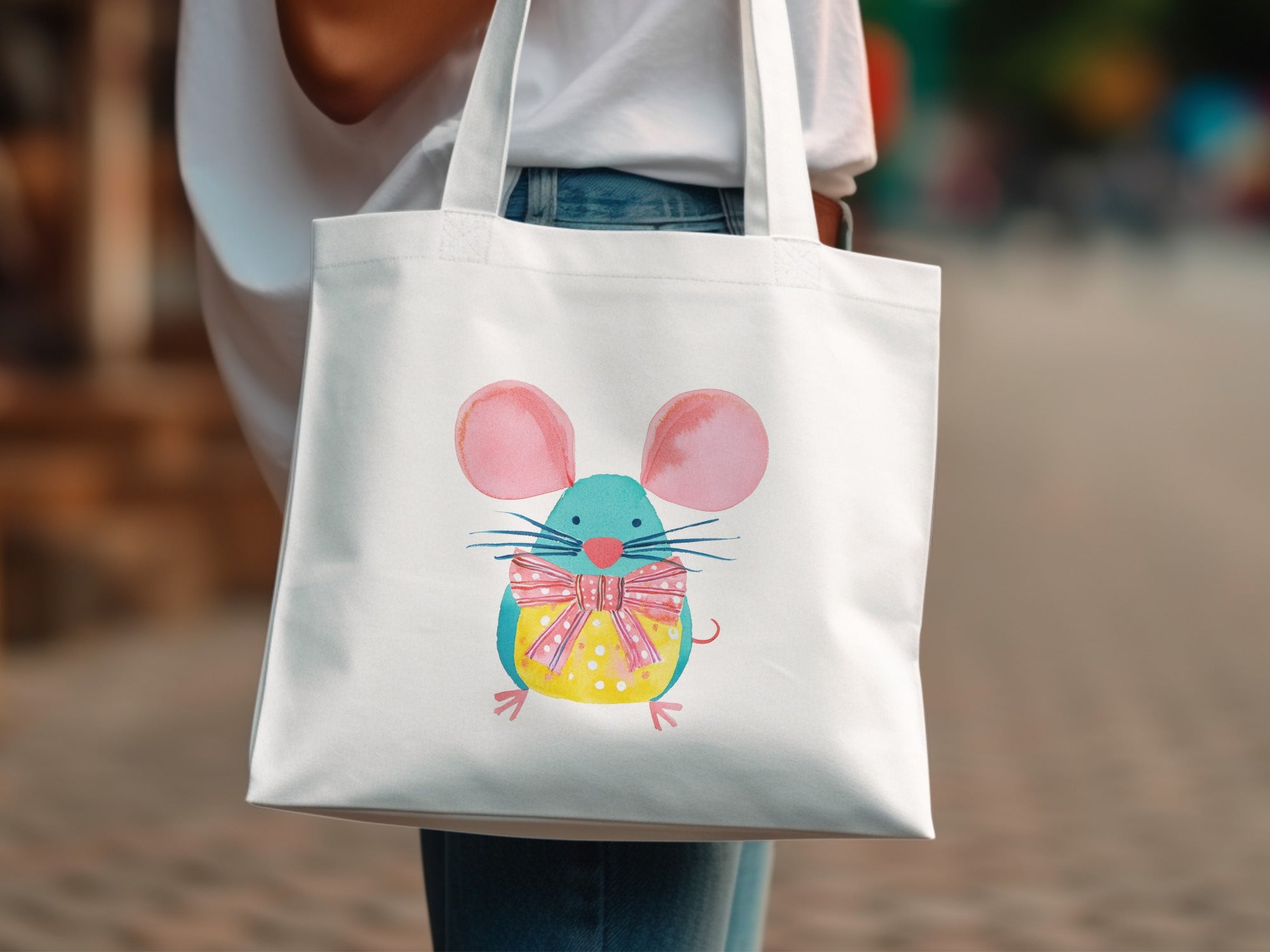 White tote bag with a cartoon mouse wearing a blue bow tie.