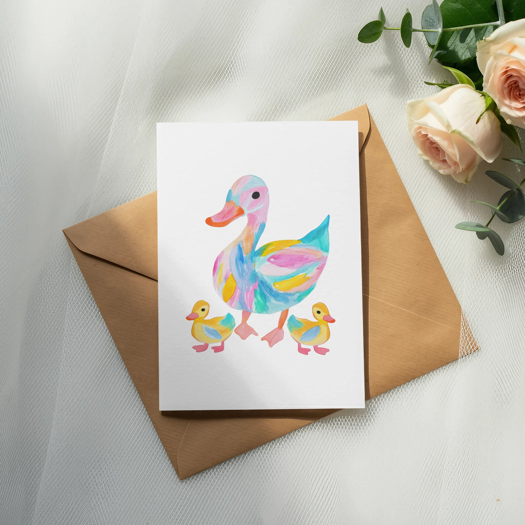 Watercolor painting of a colorful duck and two ducklings on a card.