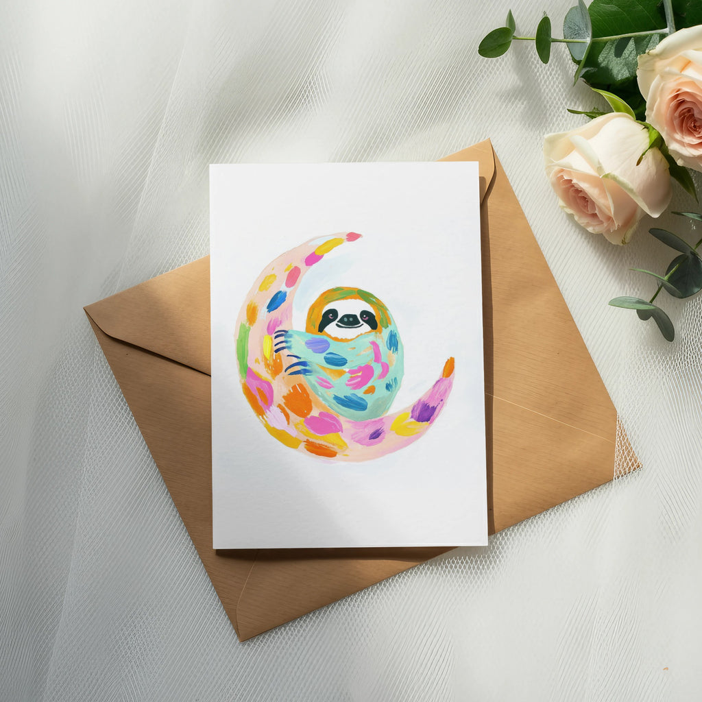 Sloth on a colorful crescent moon, on a brown envelope and roses.