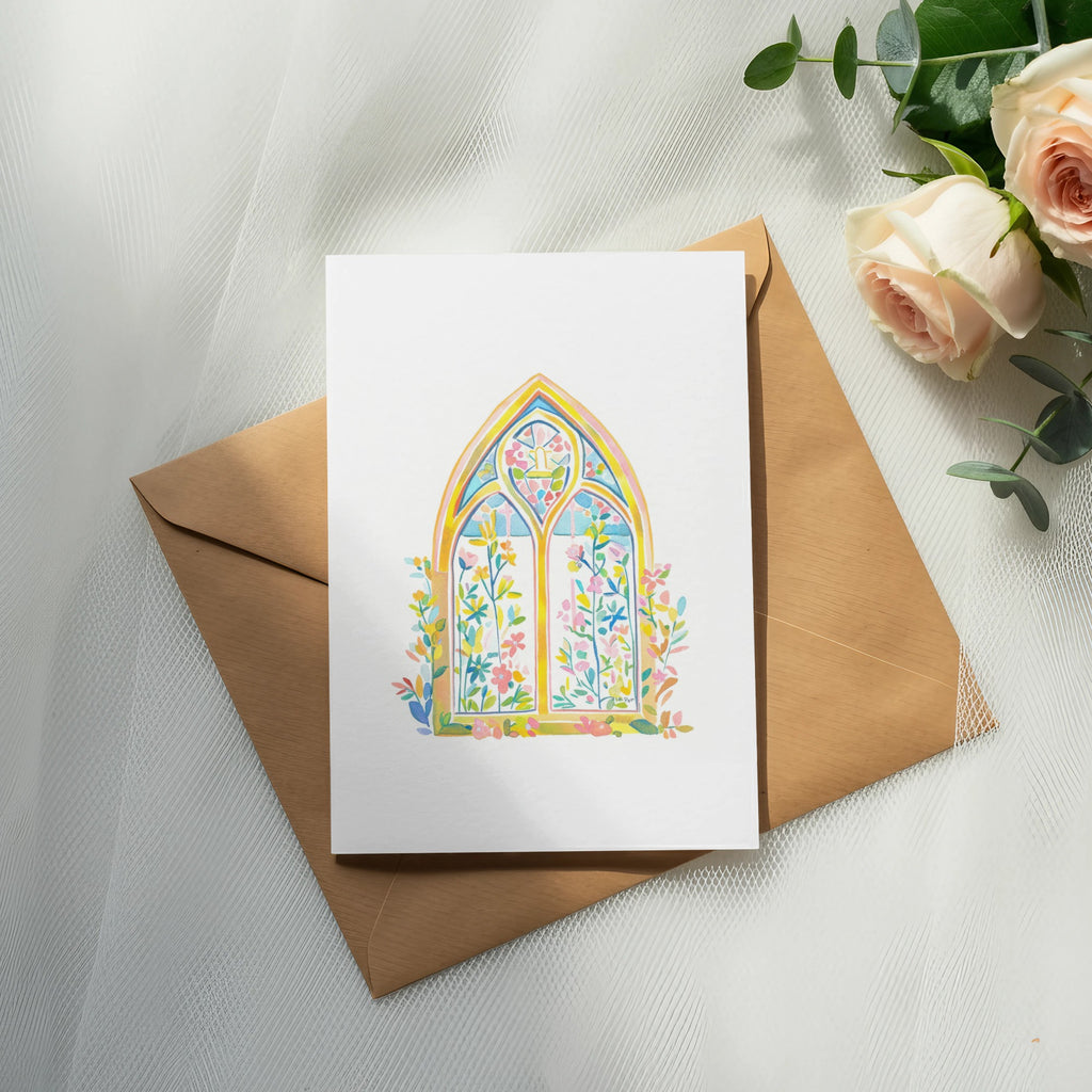 White greeting card with colorful stained-glass window and floral design on brown envelope.