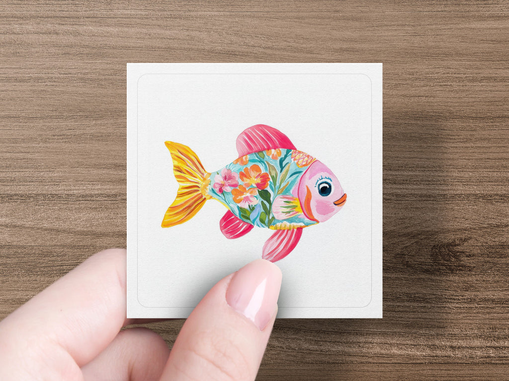 Pink and orange stylized fish illustration with floral pattern on white card.