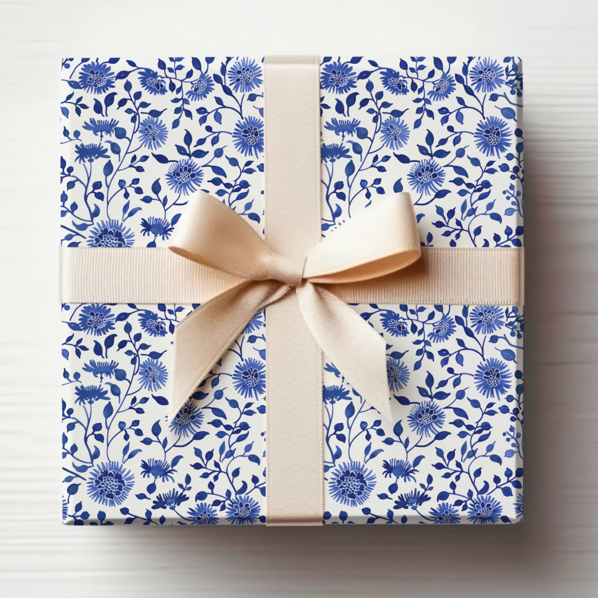 Elegant Blue Floral Gift Wrapping with Bow and Ribbon