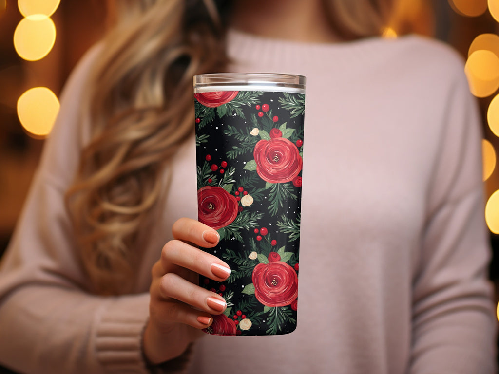 Woman holding tumbler with red floral design and greenery on black background, Floral Arrangement on Black Background Artful Design