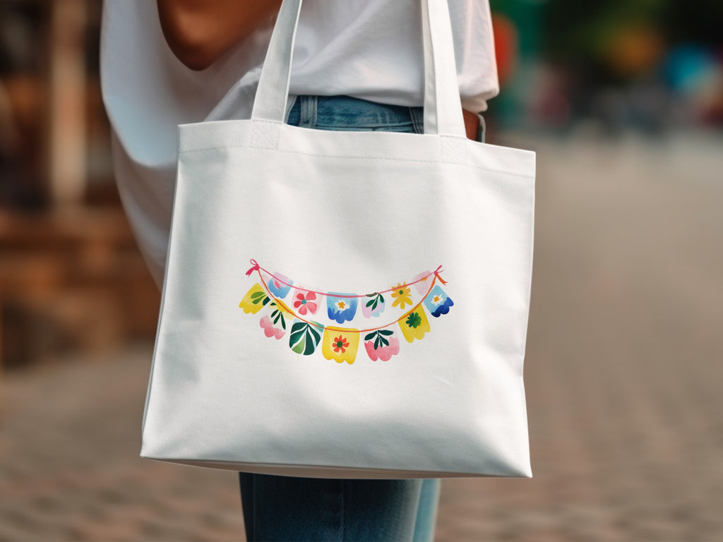 White canvas tote bag with a colorful floral garland print.