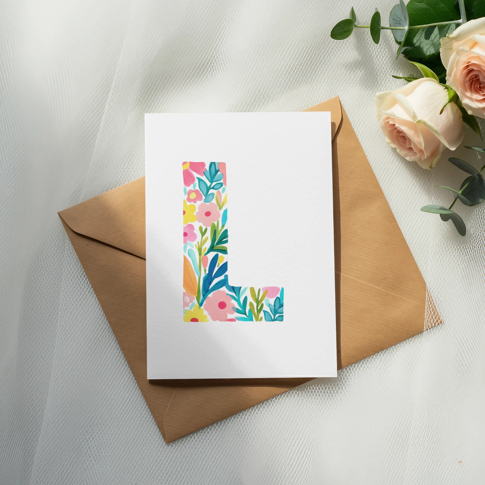 White card with colorful floral pattern forming the letter L.