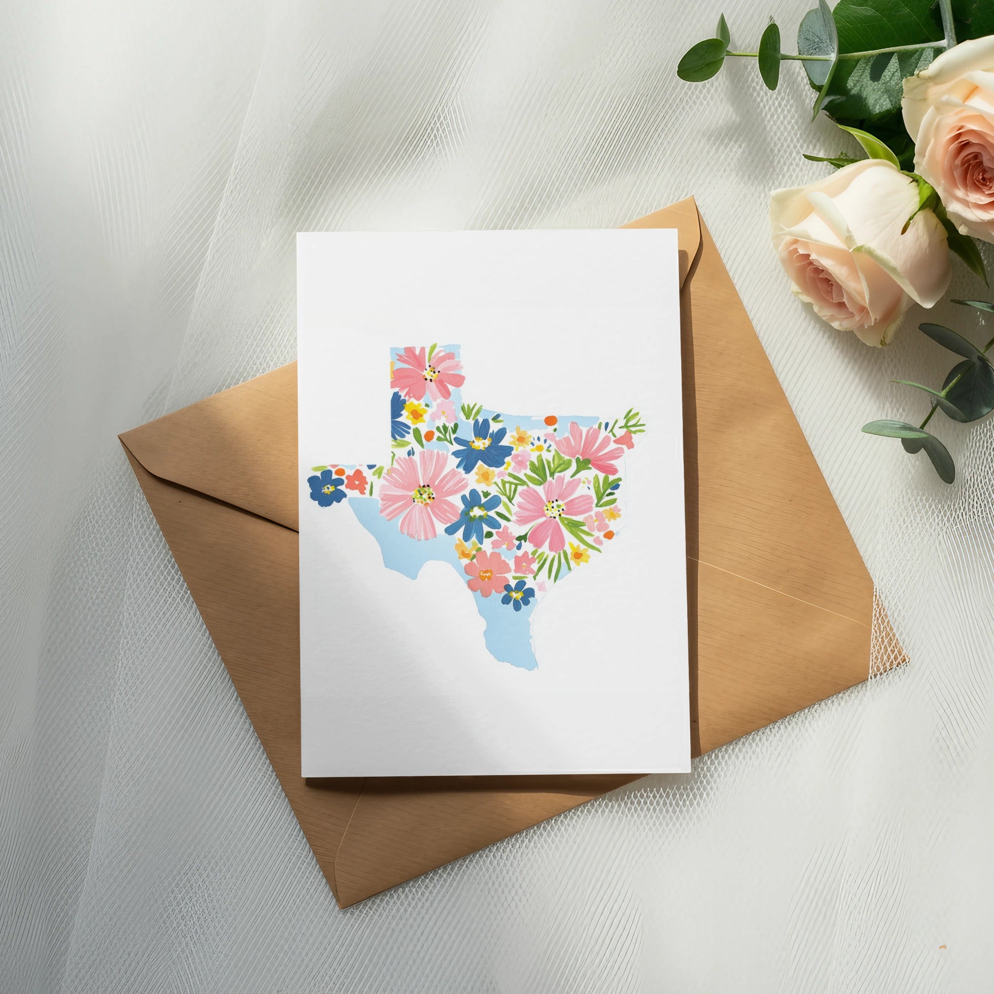 Card with Texas outline filled with colorful flowers on an envelope.