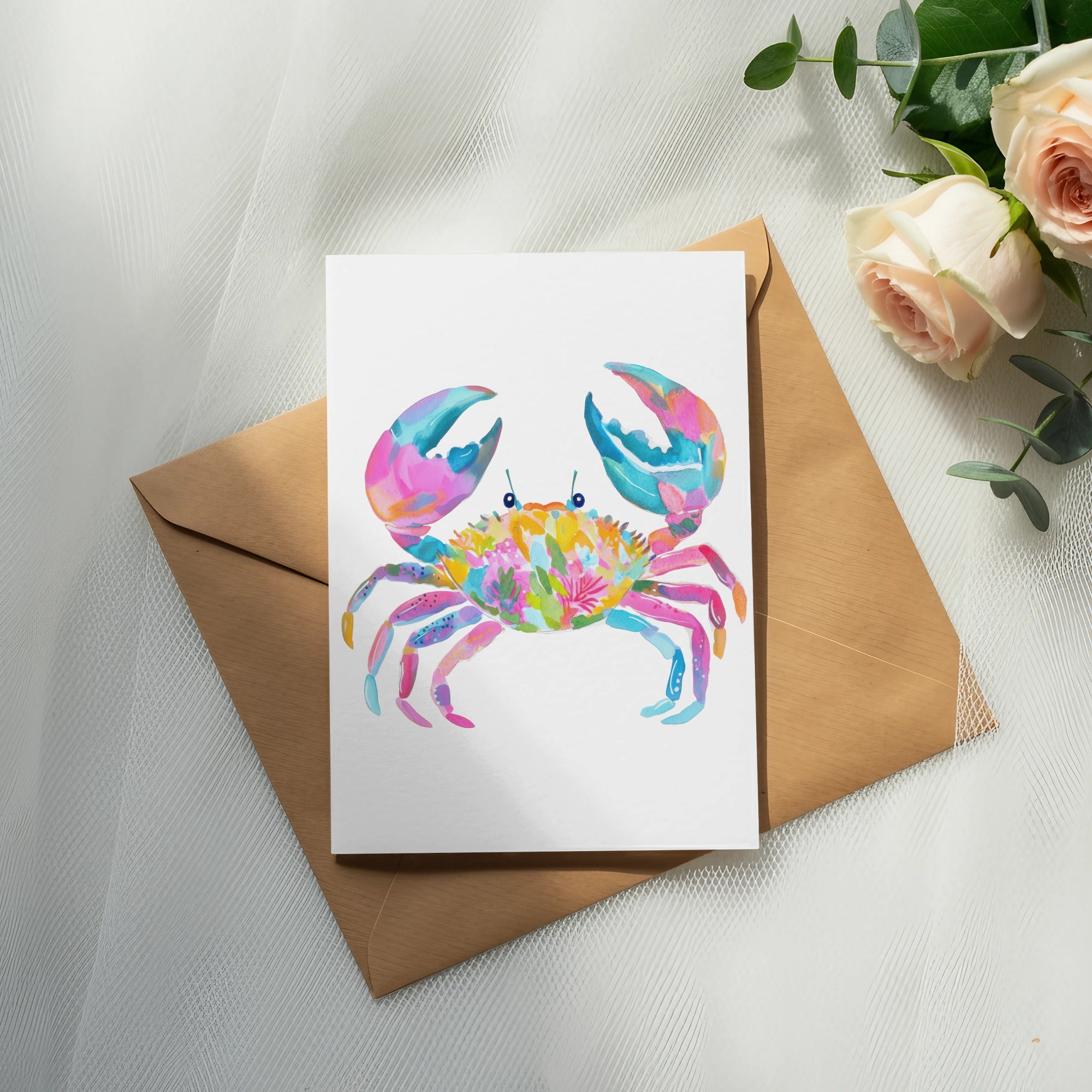 Watercolor crab illustration on card, with envelope and roses.