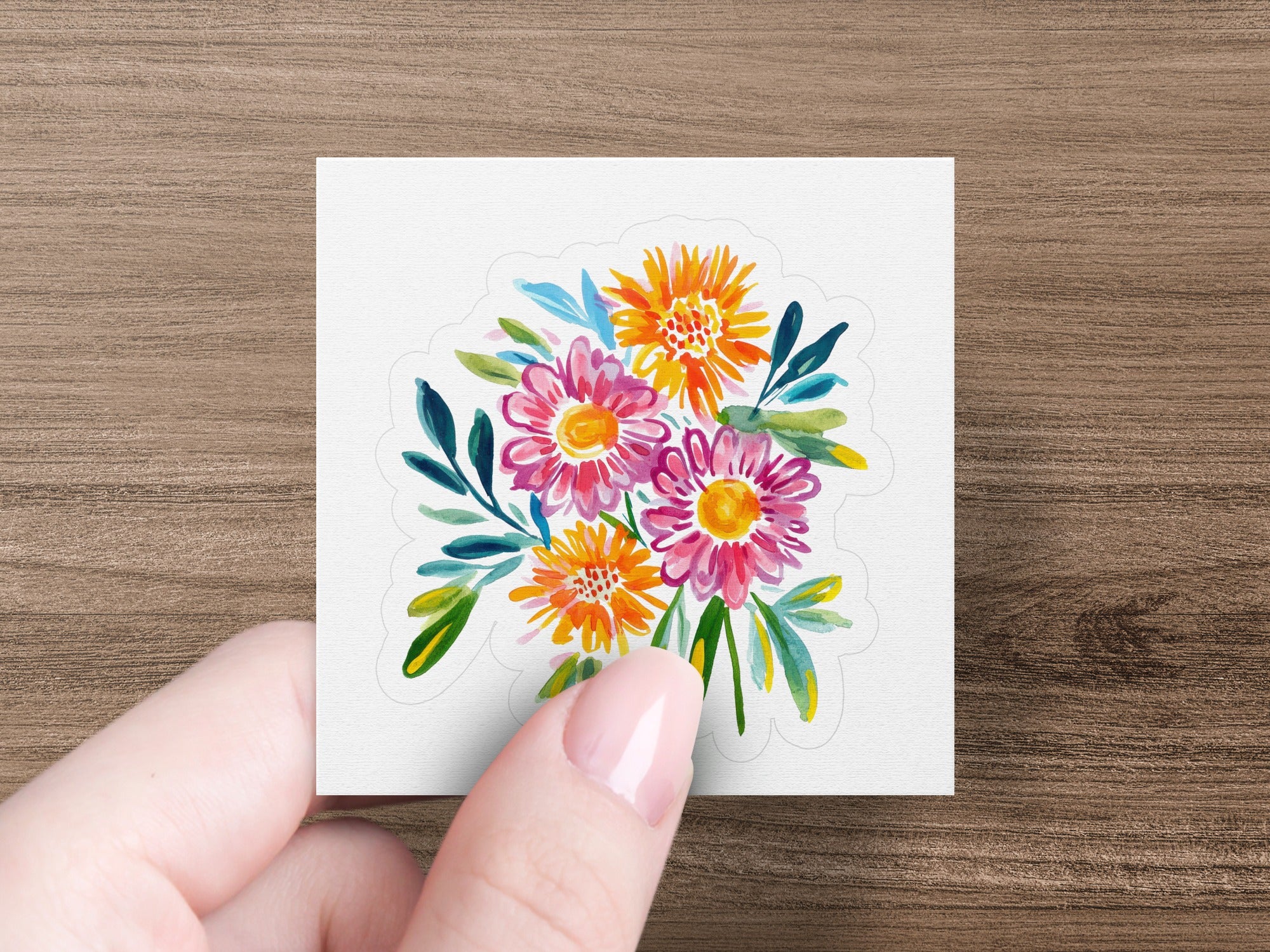Watercolor bouquet of colorful flowers with green leaves.