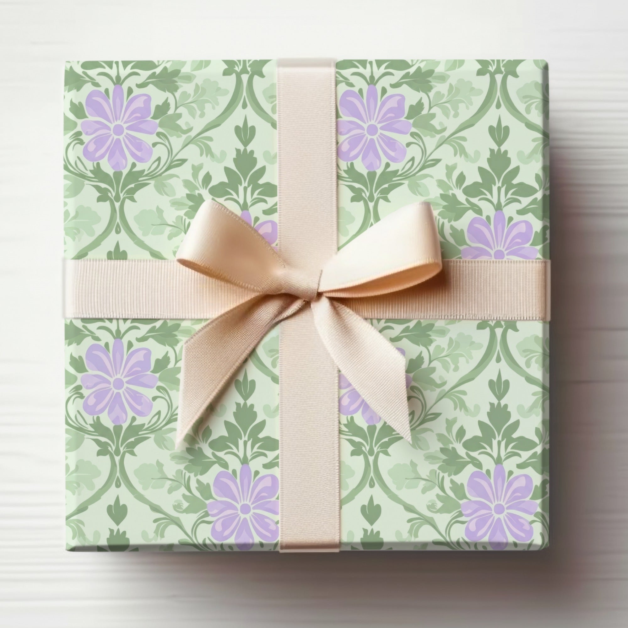 Light green gift wrap with purple flowers and beige ribbon bow.