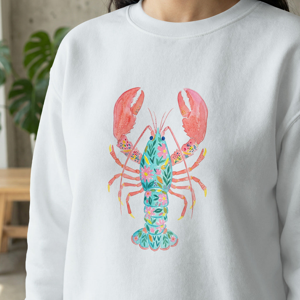 White sweatshirt with a colorful floral lobster illustration.