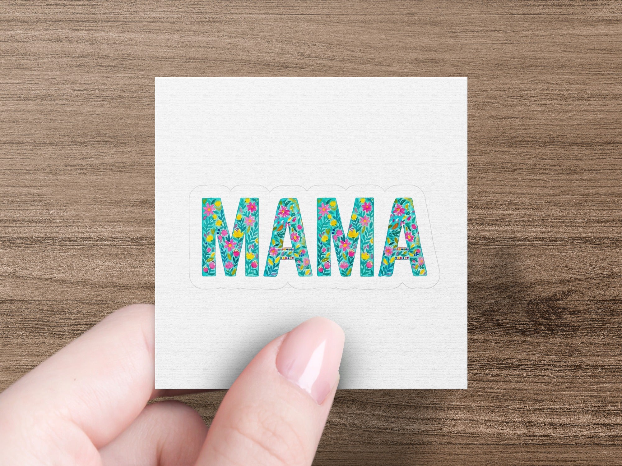 "Mama" text sticker with floral accents, held by a hand.