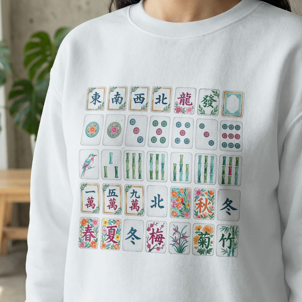 Mahjong tiles with Chinese characters and illustrations on a white sweatshirt.
