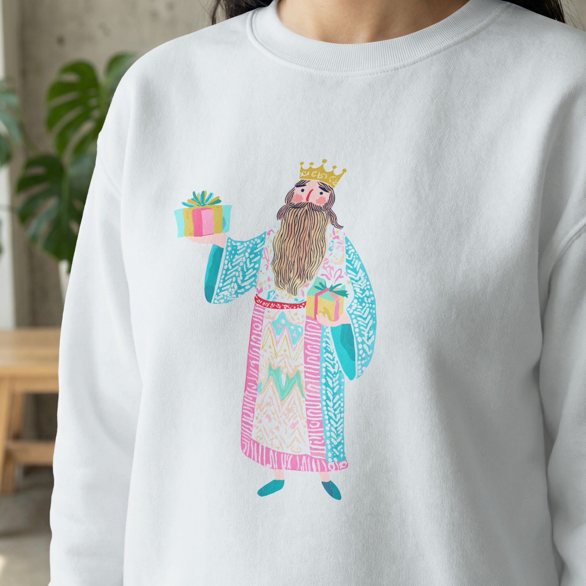 White sweatshirt with illustration of a king holding two gift boxes.
