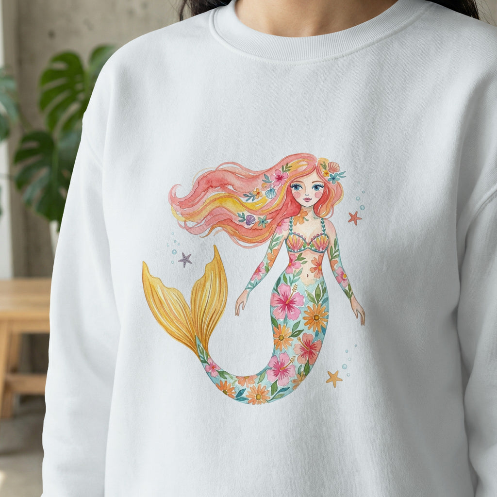 White sweatshirt with a watercolor mermaid design of flowers and scales.