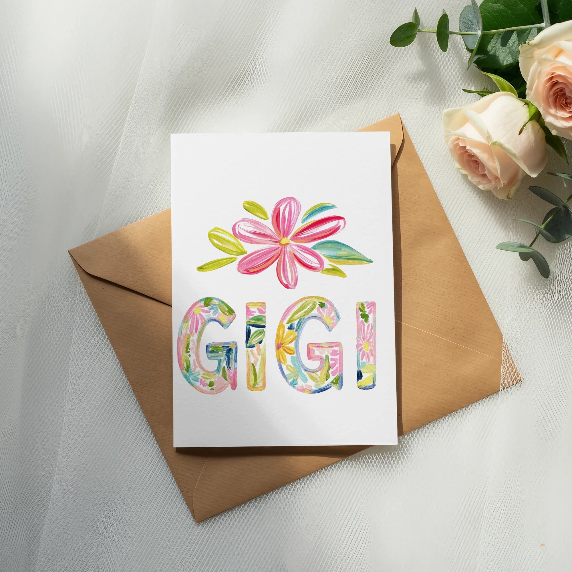 Card with colorful floral letters spelling "GIGI" on an envelope.