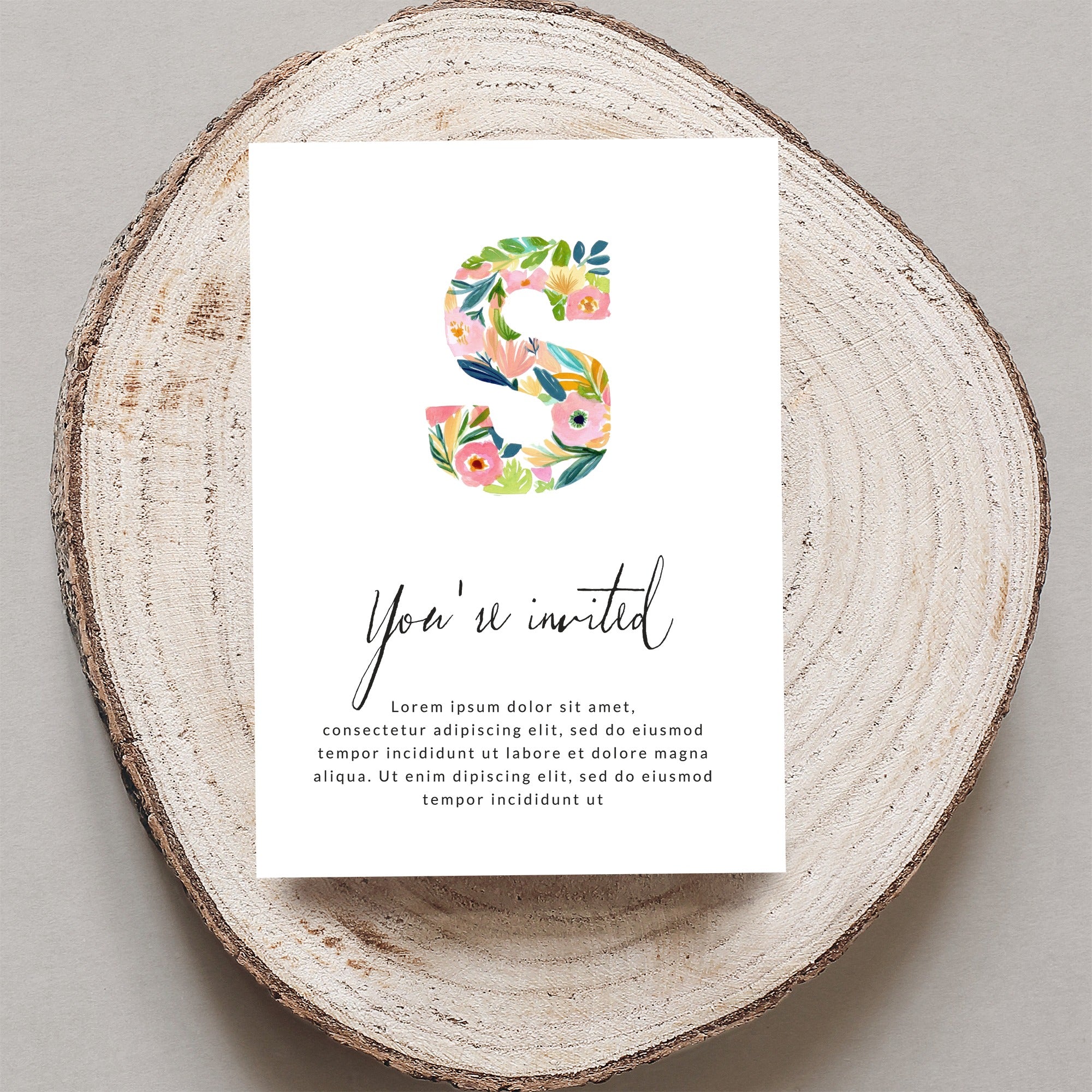 Invitation card with a floral "S" and text "You're invited".