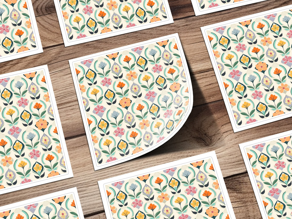 Floral pattern on paper squares scattered on a wooden surface.
