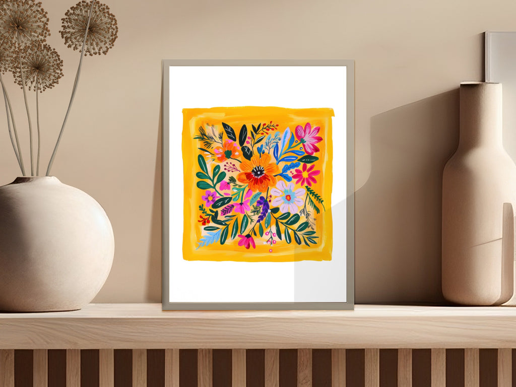 Vibrant floral art with yellow background in a frame on a shelf.