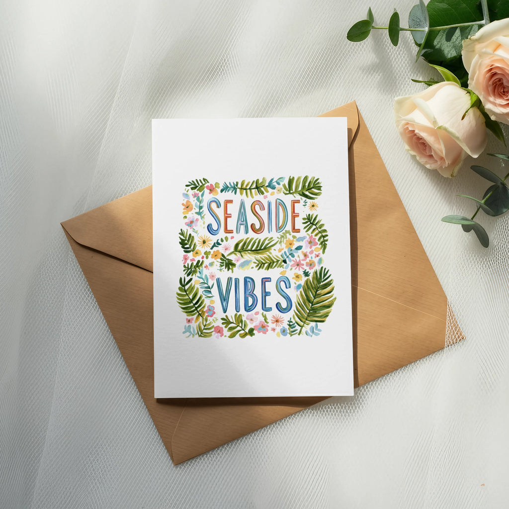 Card with "SEASIDE VIBES" text surrounded by colorful leaves and flowers.