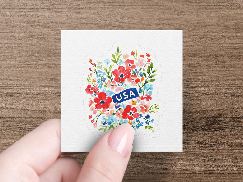 Floral sticker with "USA" in a red ribbon on a white background.
