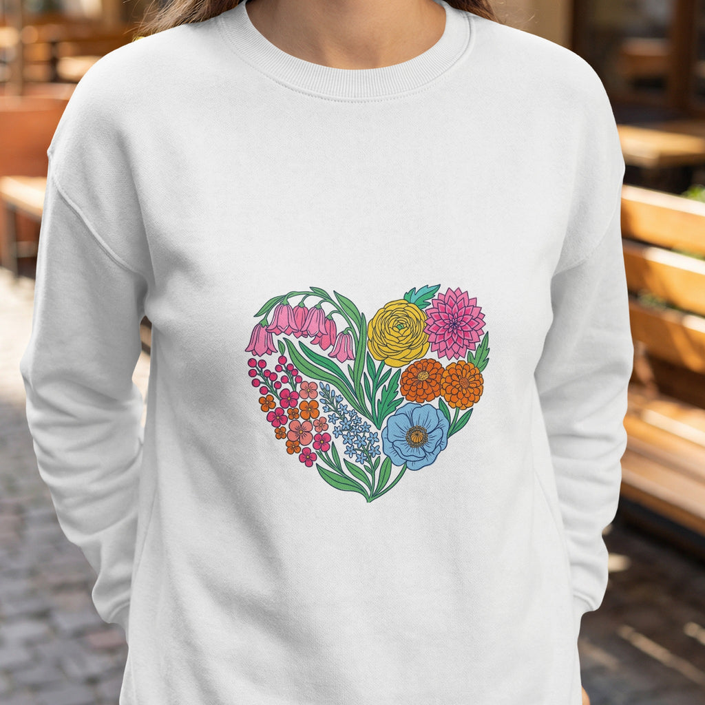 White sweatshirt with a colorful heart-shaped floral design.