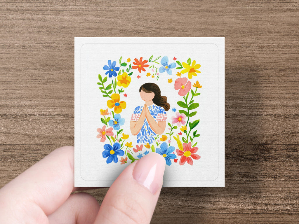 Woman with hands pressed together in floral frame.