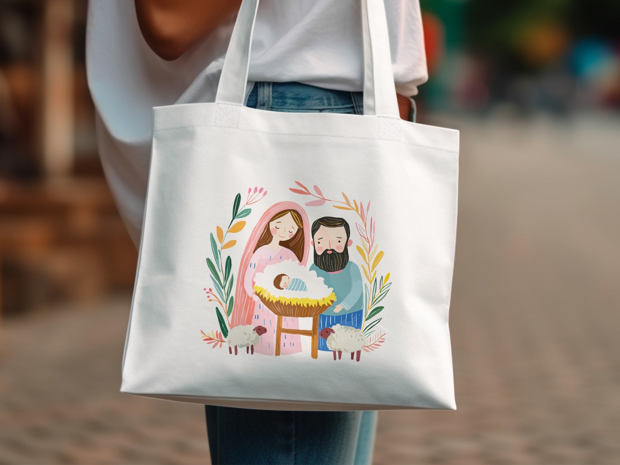 Nativity scene with Mary, Joseph, baby Jesus, and sheep on a white tote bag.