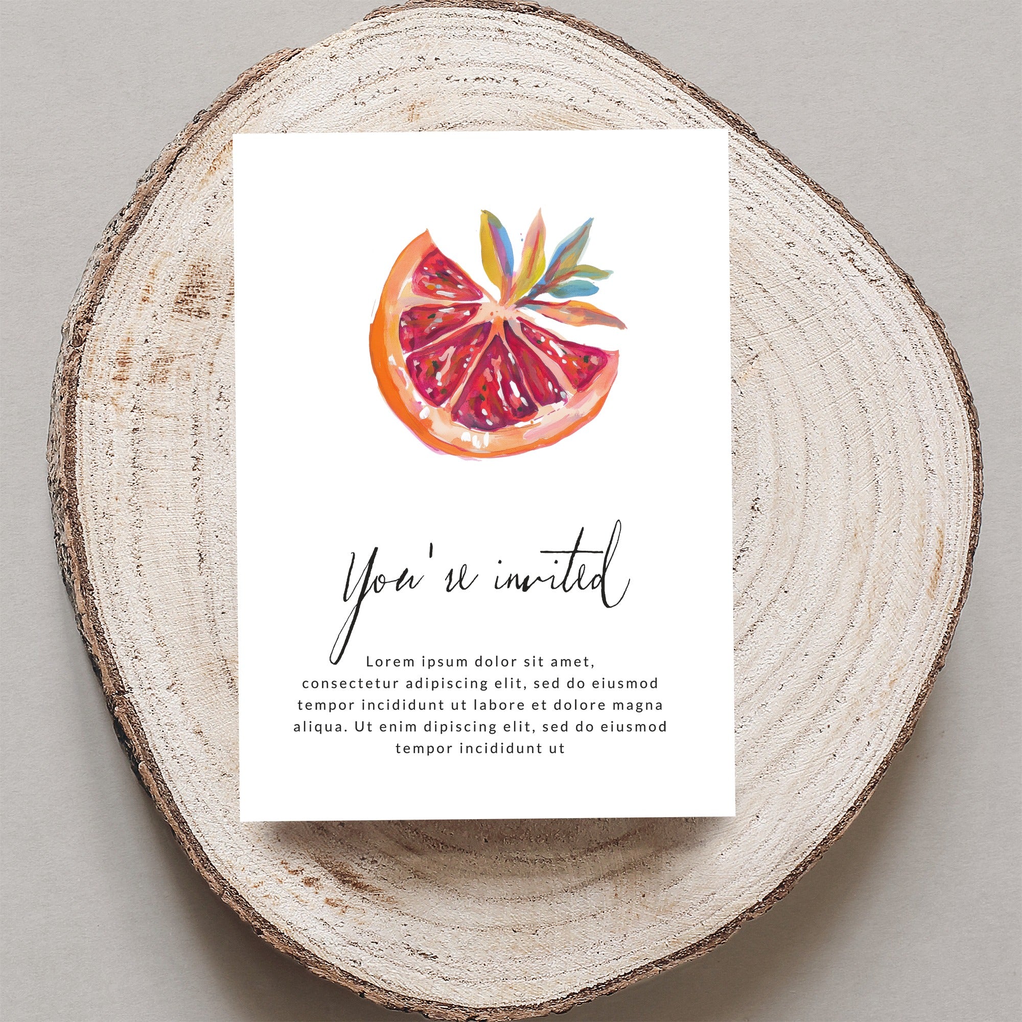 Invitation with watercolor citrus slice and "You're invited" text.