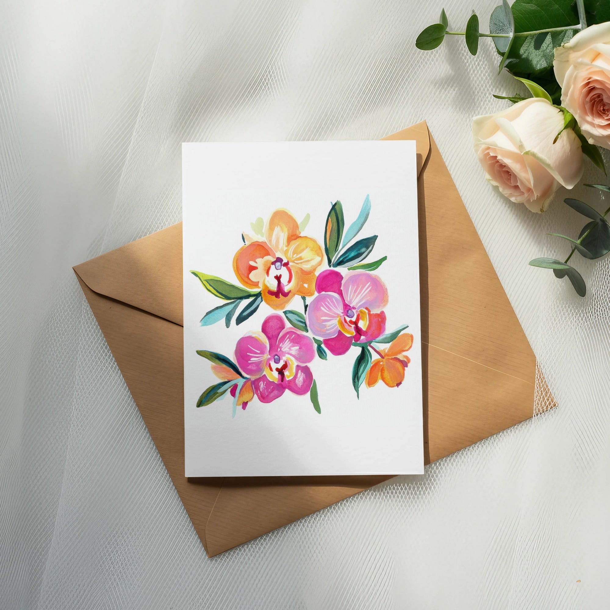 Watercolor orchids on white cardstock atop a brown envelope with roses.