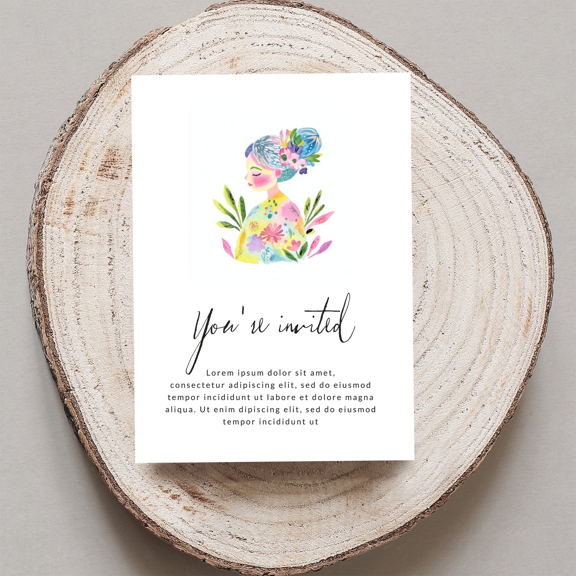 Invitation card with "You're invited" text and floral illustration on wood.