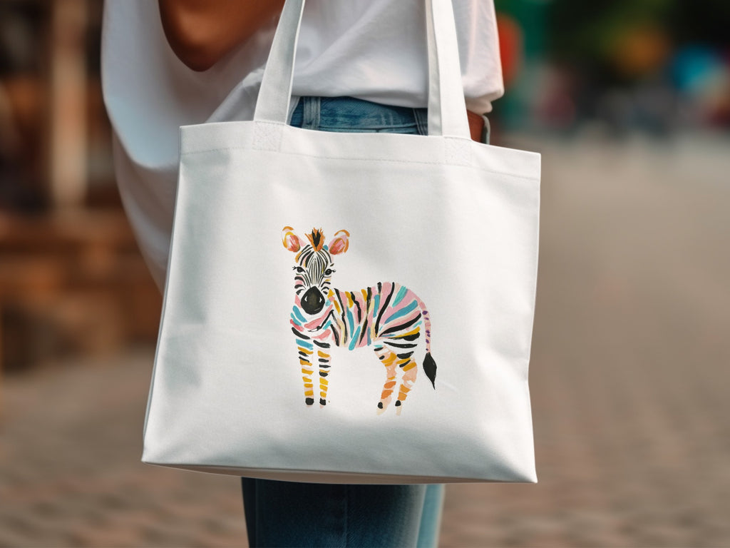 White canvas tote bag with a colorful watercolor zebra illustration.