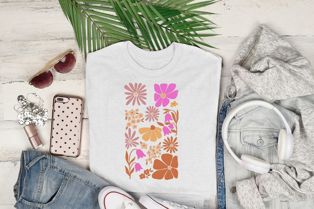 White t-shirt with abstract floral pattern in pink, orange, and brown.