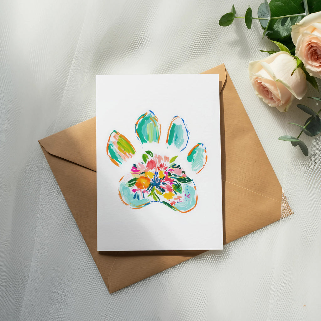Card with colorful floral paw print on brown envelope, with roses and eucalyptus.