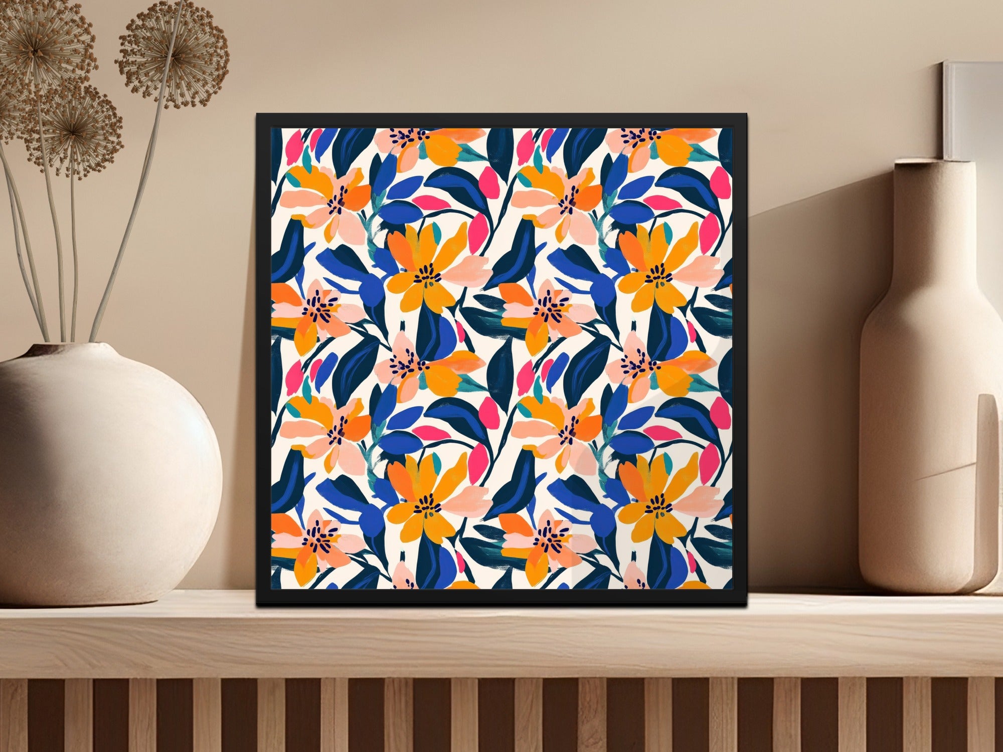 Framed artwork with a vibrant floral pattern on a shelf.