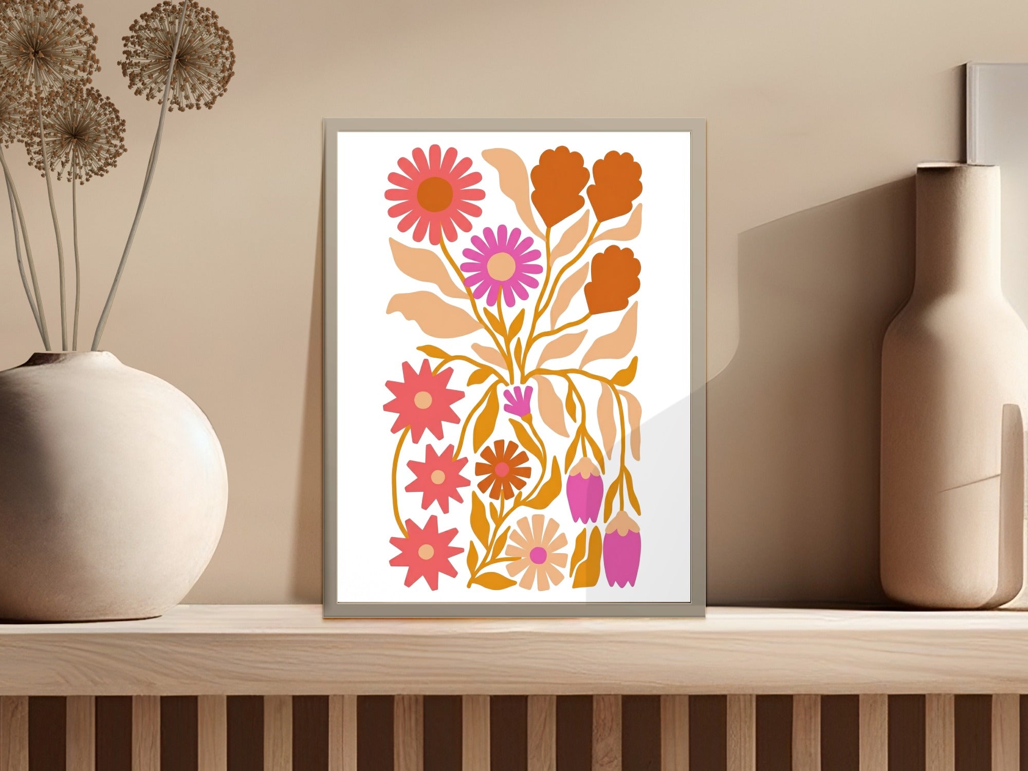 Framed artwork featuring abstract floral illustrations in orange, pink, and yellow.