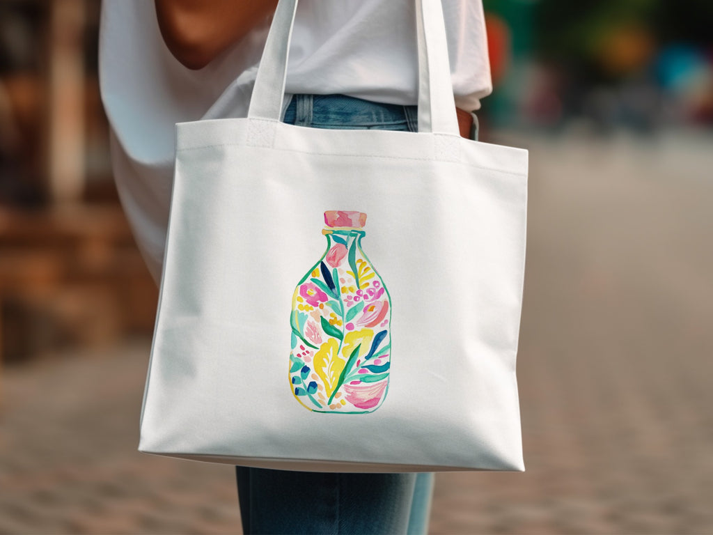 White tote bag with a colorful floral bottle design.