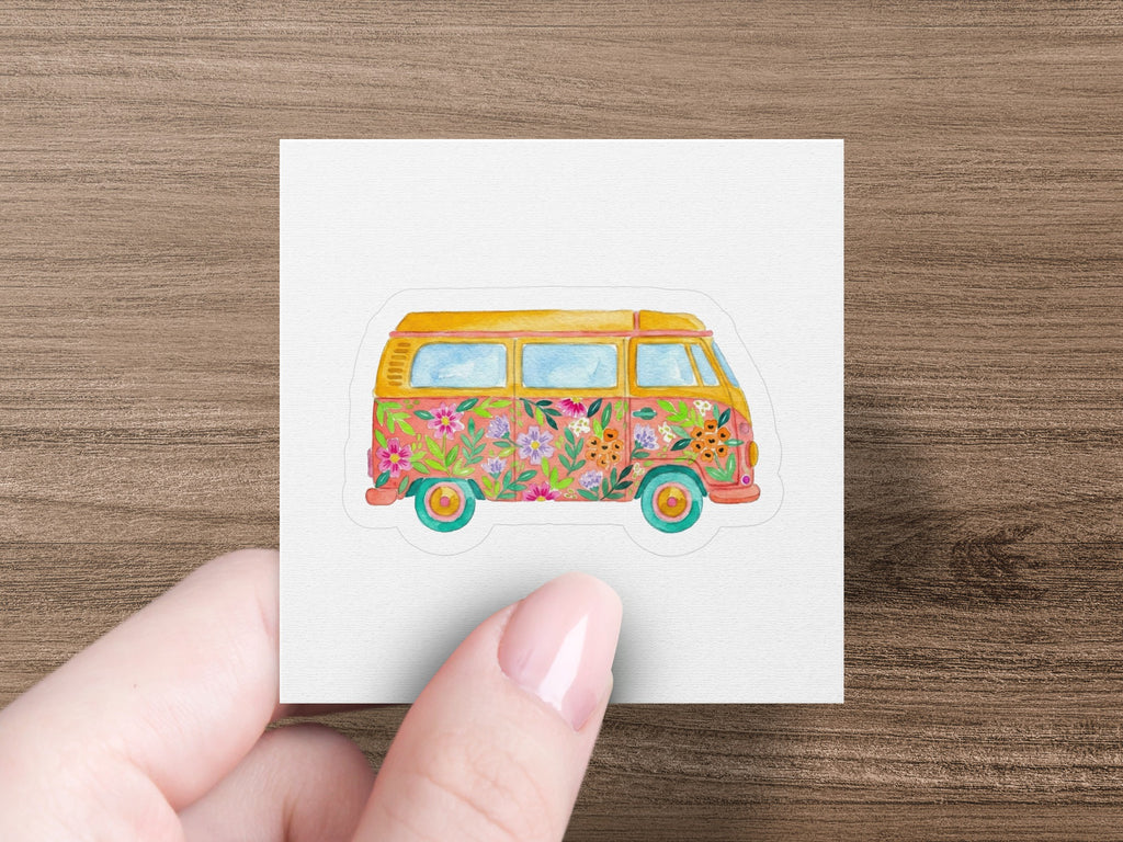 Retro van with floral pattern and sunset background.