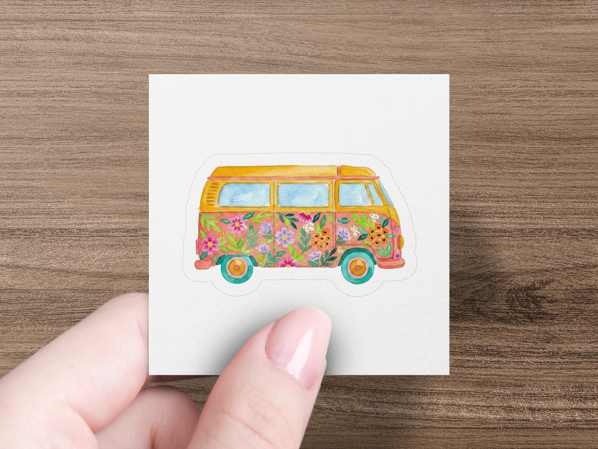 Retro van with floral pattern and sunset background.