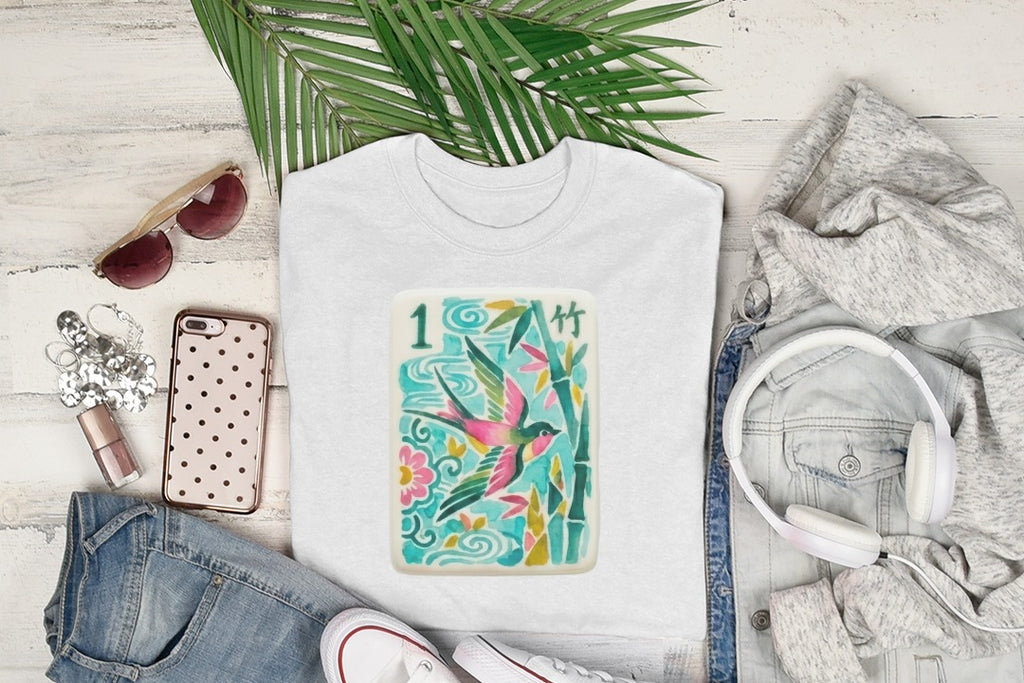 White t-shirt with a bamboo and swallow design, sunglasses, and headphones.