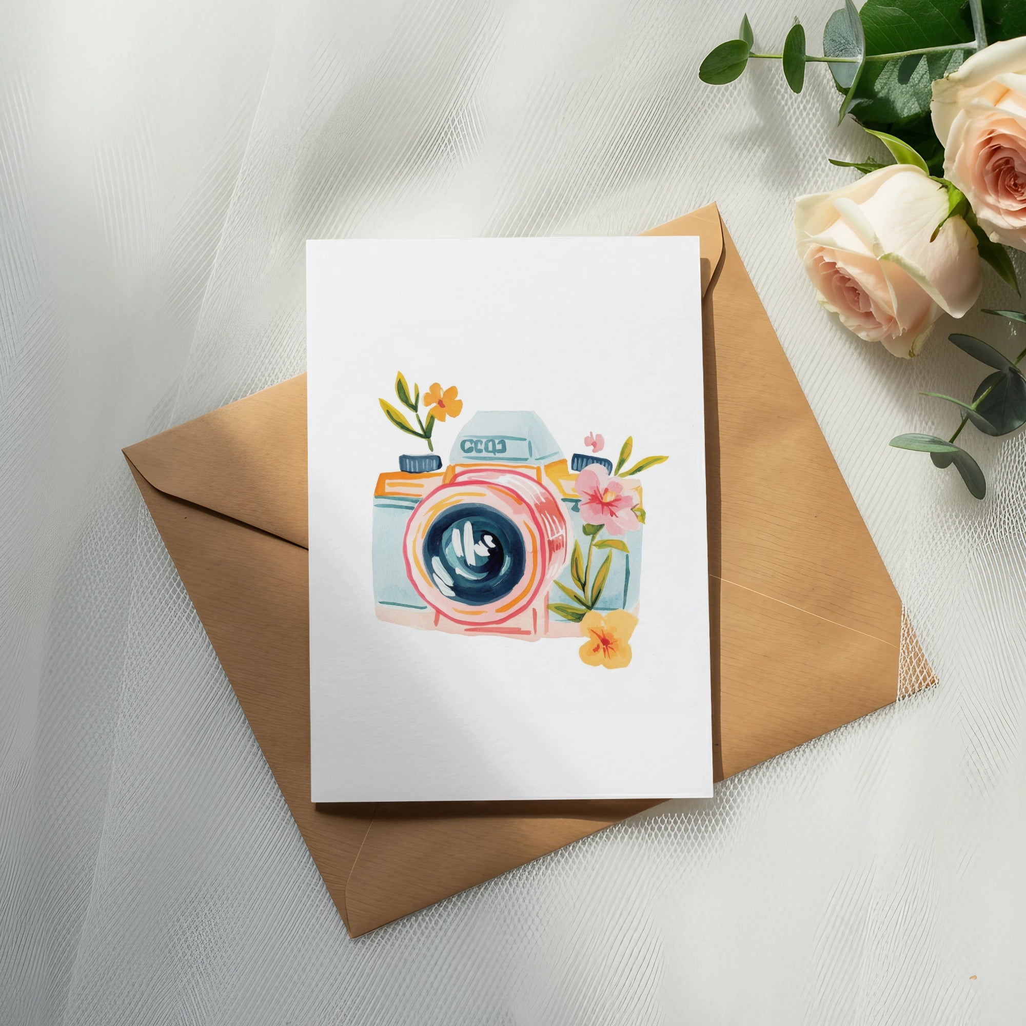 Watercolor illustration of a vintage camera on a card, with roses and eucalyptus.