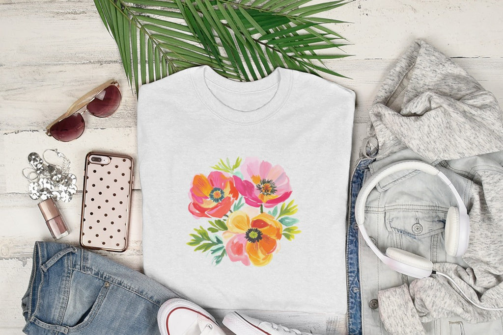 White t-shirt with a floral watercolor design of poppies and leaves.