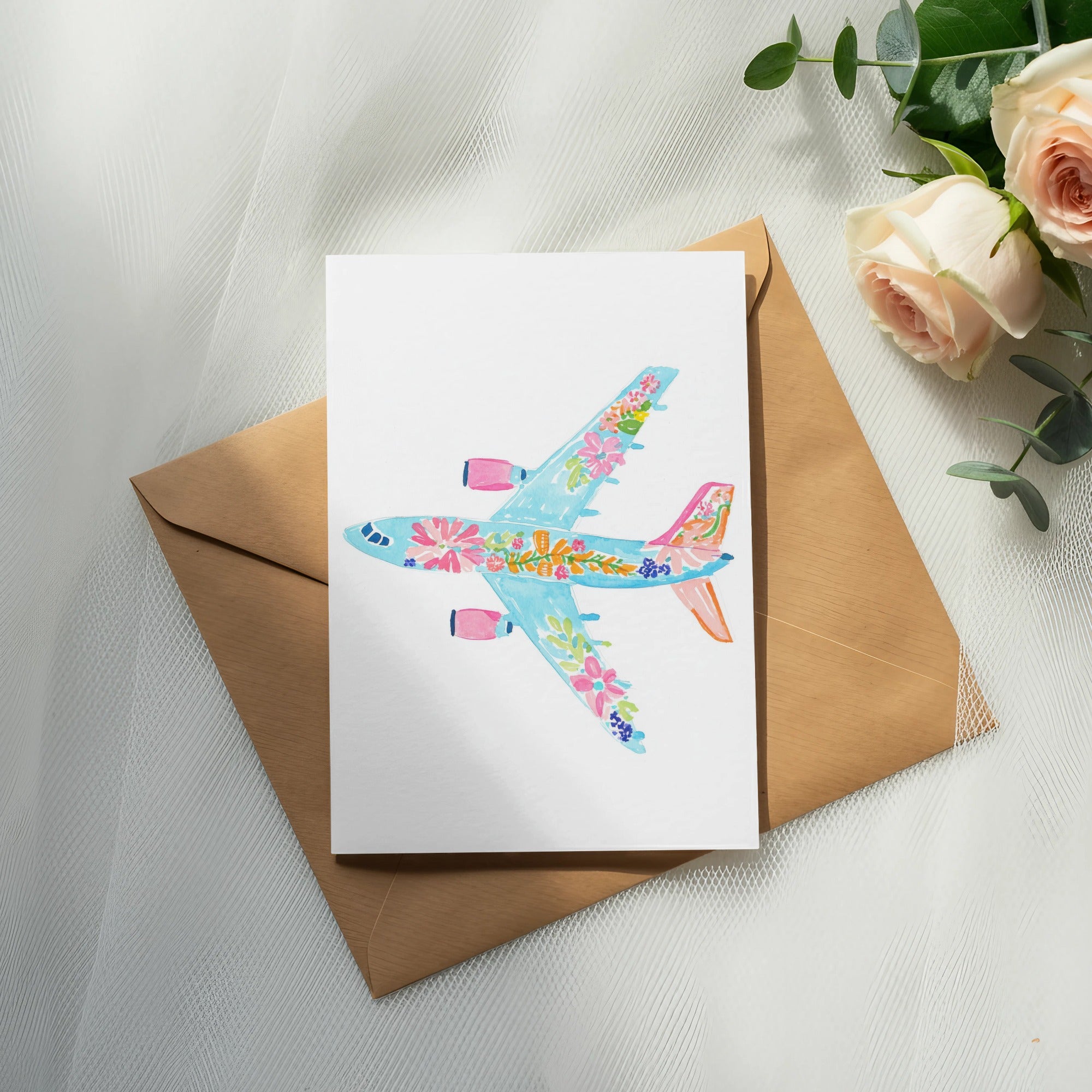 Card featuring a watercolor airplane with floral details on a brown envelope.