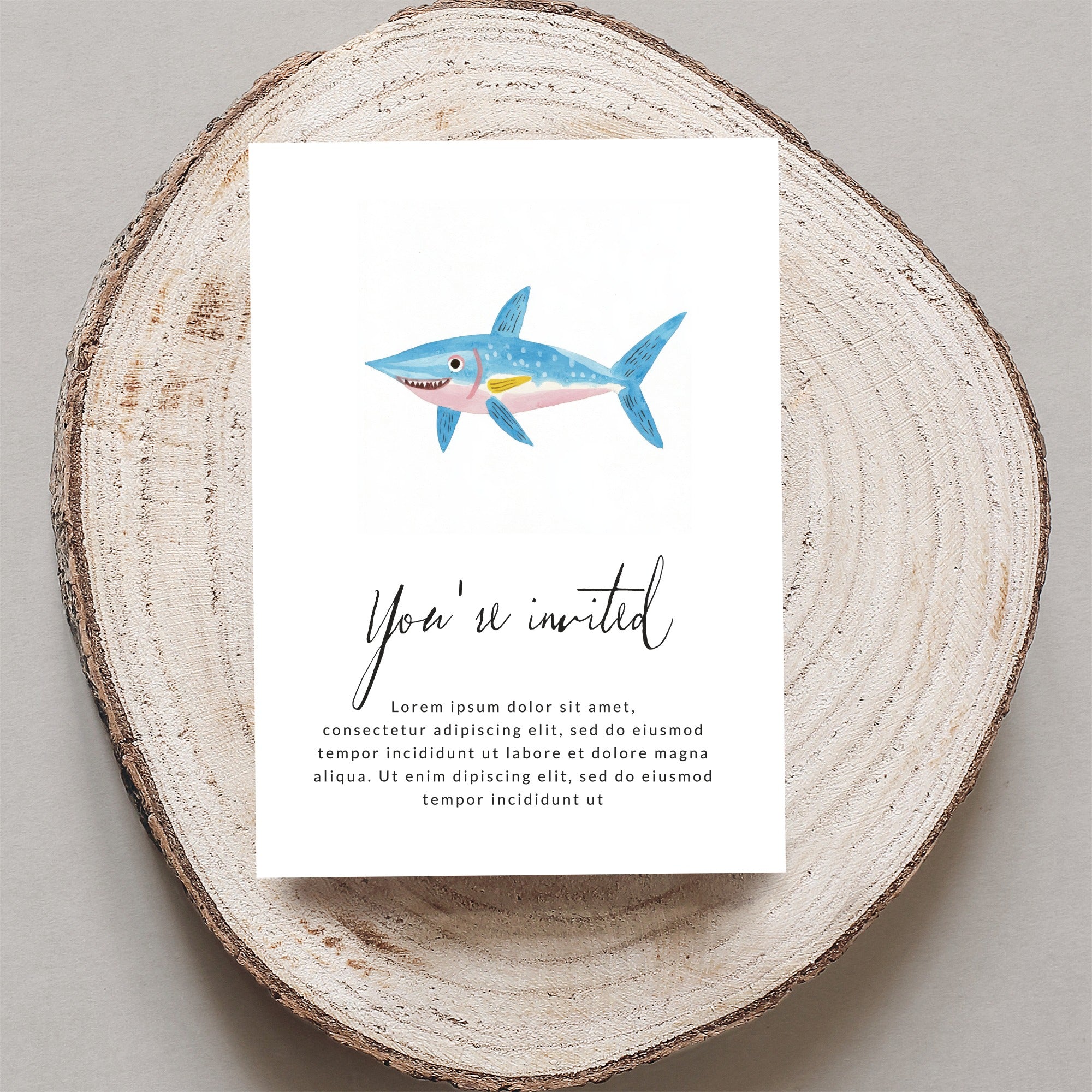 Invitation with a cartoon shark and "You're invited" text.
