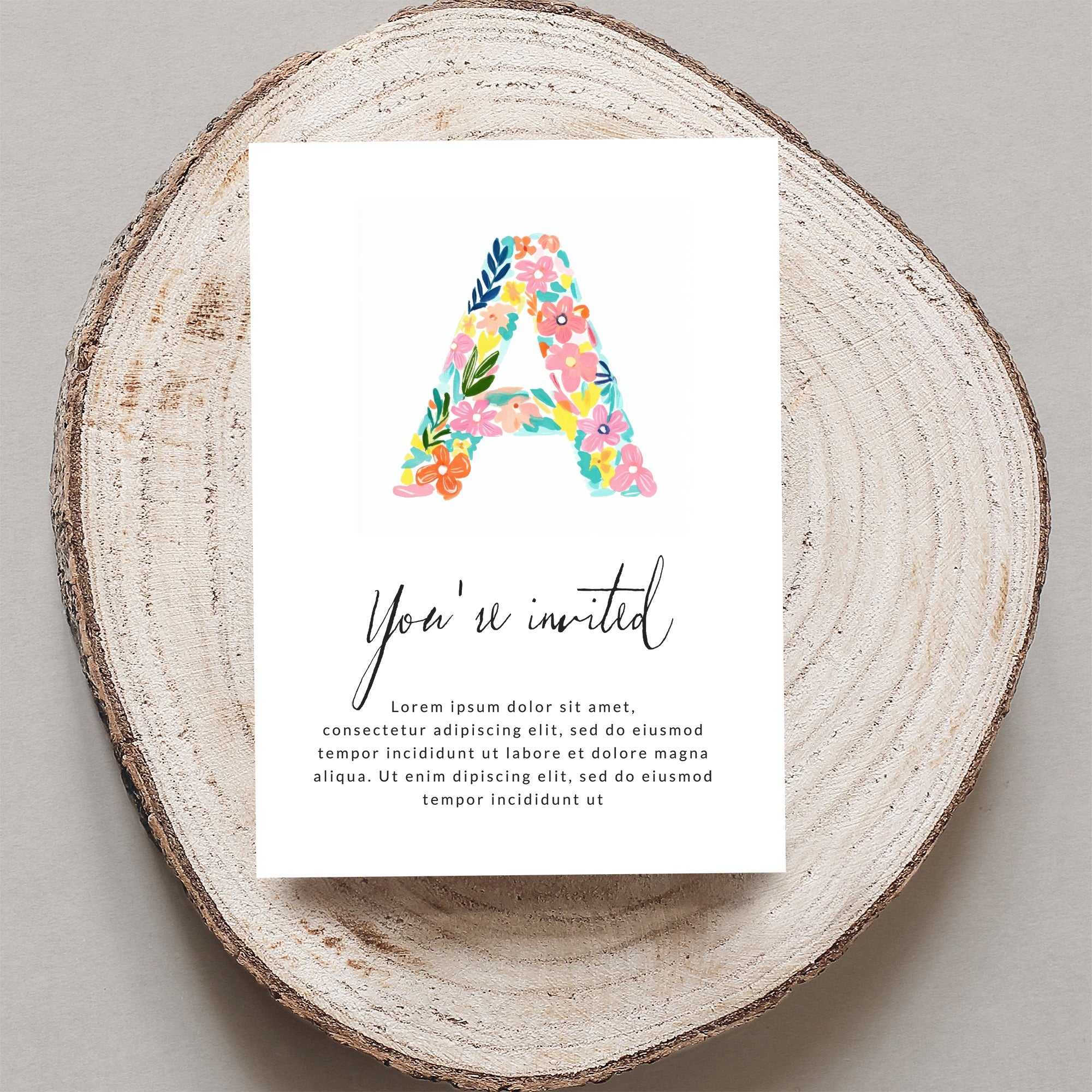Invitation card with floral letter A and placeholder text.