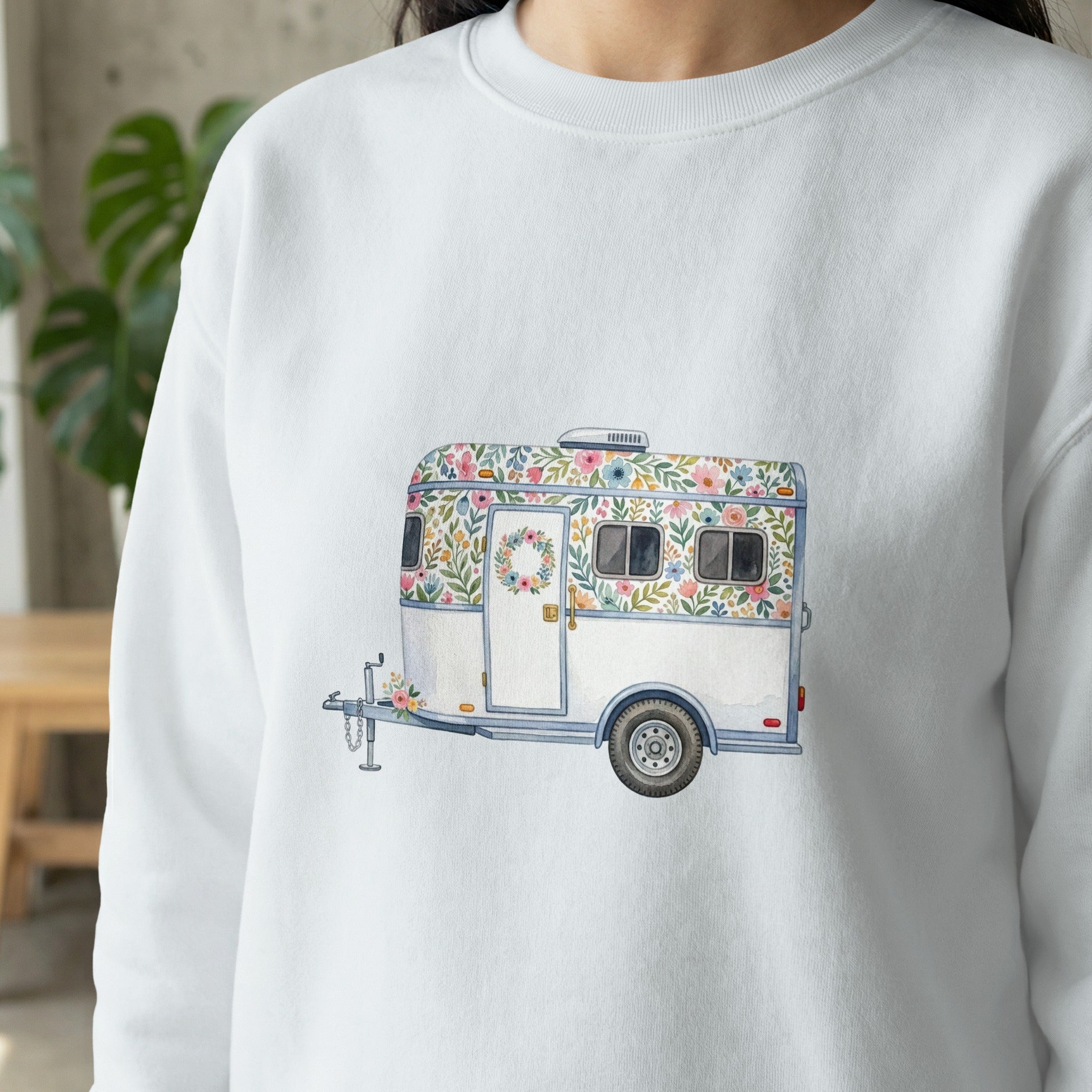 White sweatshirt with a floral trailer illustration.