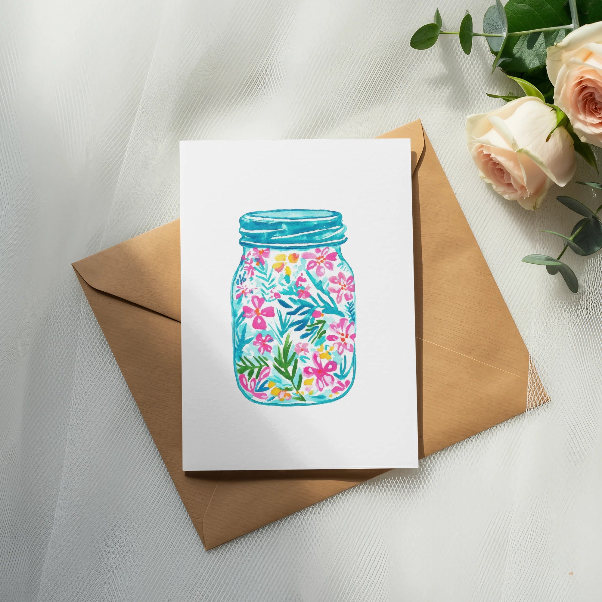 Card with watercolor floral design inside a mason jar on brown envelope.