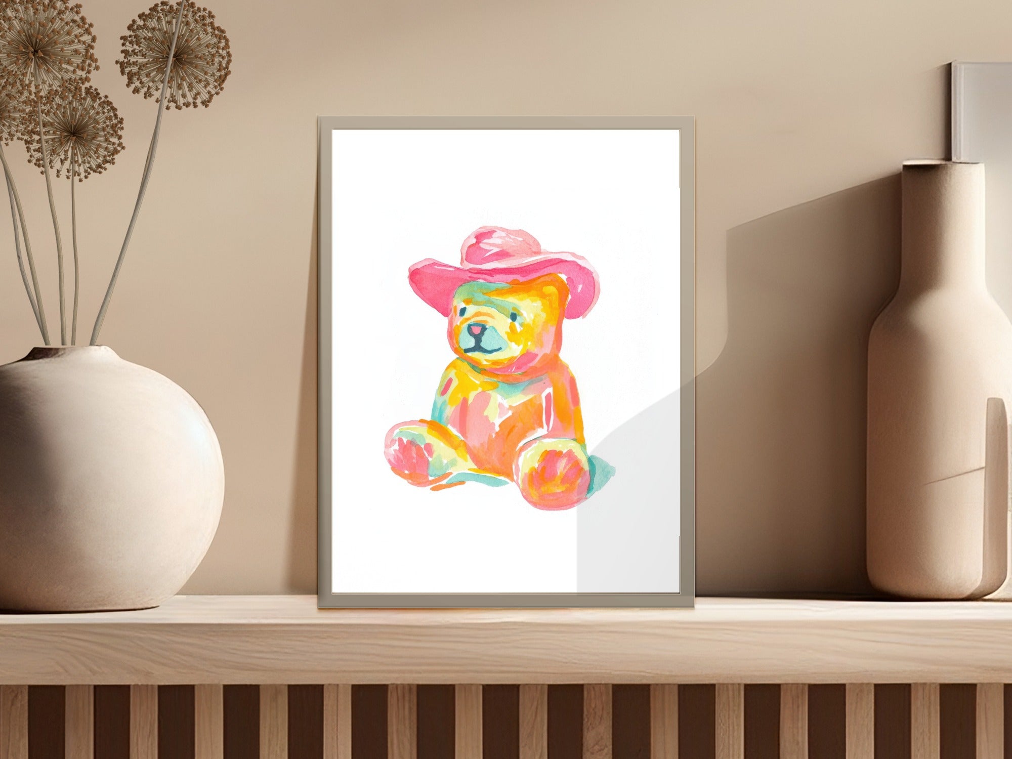 Watercolor painting of a colorful teddy bear wearing a pink cowboy hat.