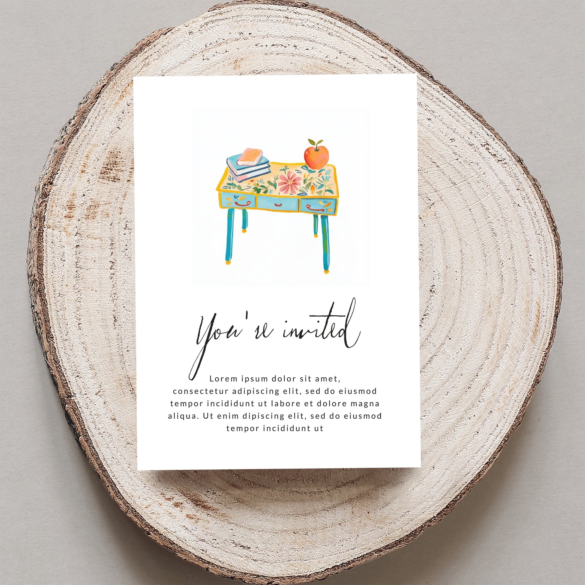 Invitation with text and illustration of a desk with books and an apple.