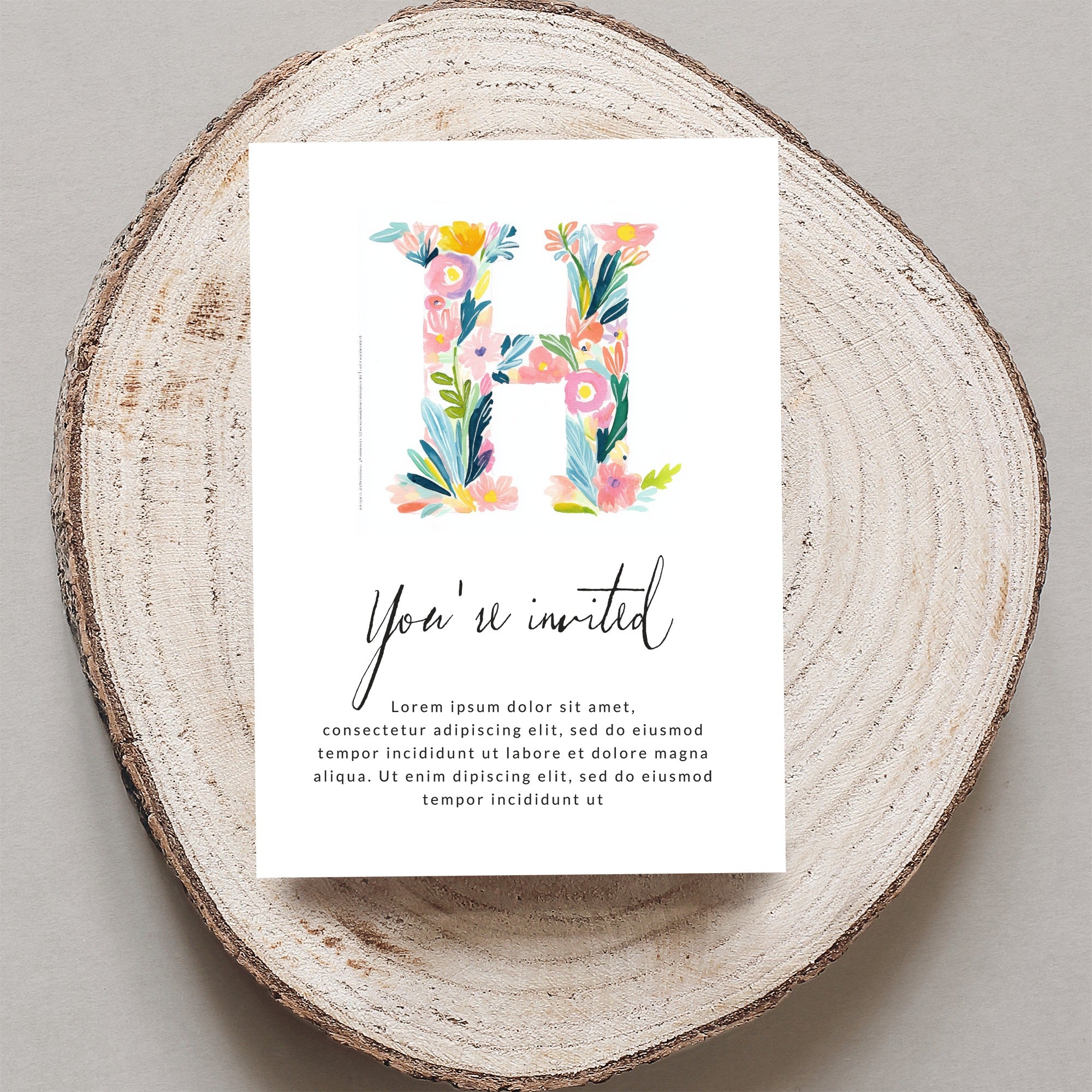 Floral letter "H" on invitation with "You're invited" and placeholder text.