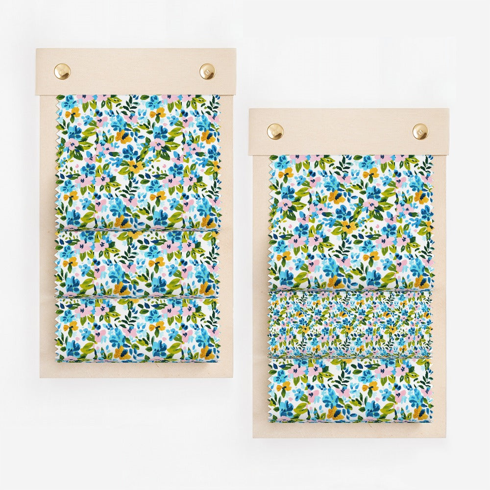 Two fabric swatches with a blue, pink, and yellow floral pattern.